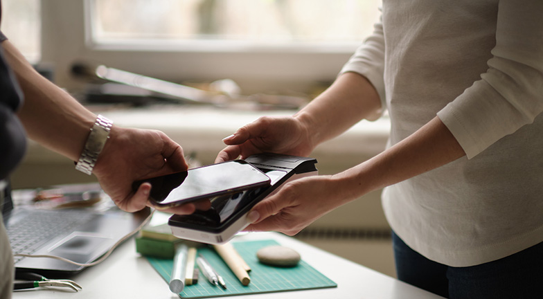 A person using temporary credit card number or a single use credit card on their mobile phone.